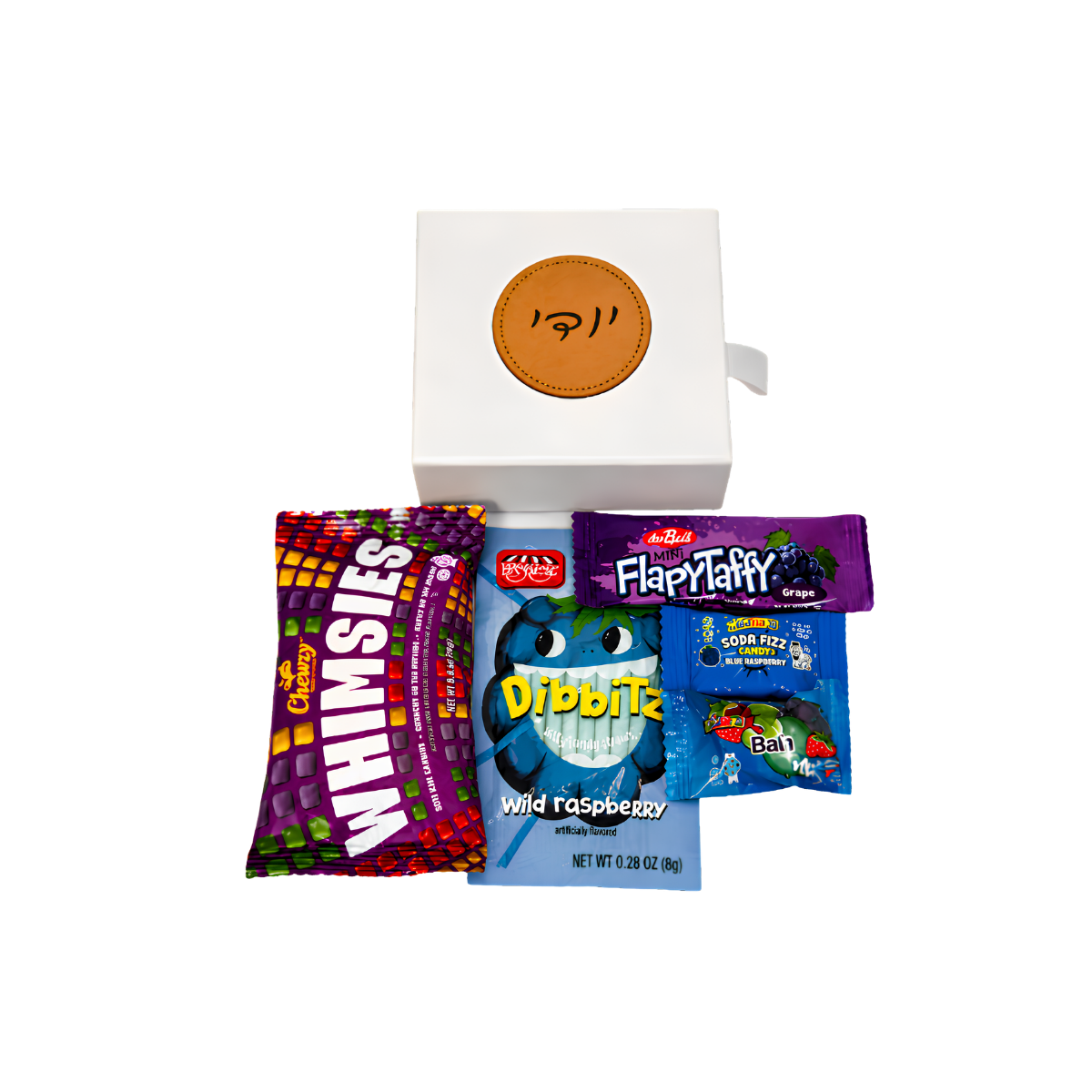 Personalized white gift box with a round brown leather-style Hebrew name tag, filled with colorful candy and snack packages.