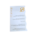 White personalized menu card featuring gold “MENU” lettering, a gold scripted “B” logo, and multiple lines of printed text.