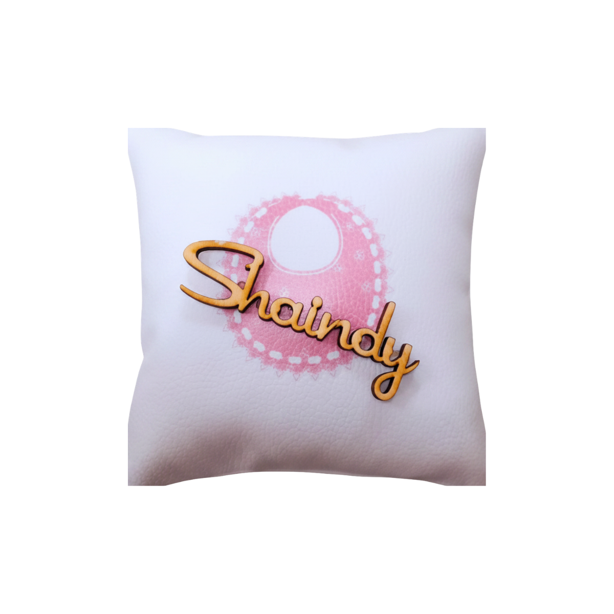 Personalized white decorative pillow featuring a pink circular design and gold script name “Shaundy.”
