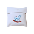 Personalized white gift pouch featuring a blue rocking horse illustration, light blue script, and a button closure.