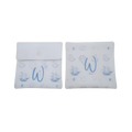 Personalized white baby gift pouches and decorative pillows featuring a light blue monogram “W” and delicate nautical-themed illustrations.