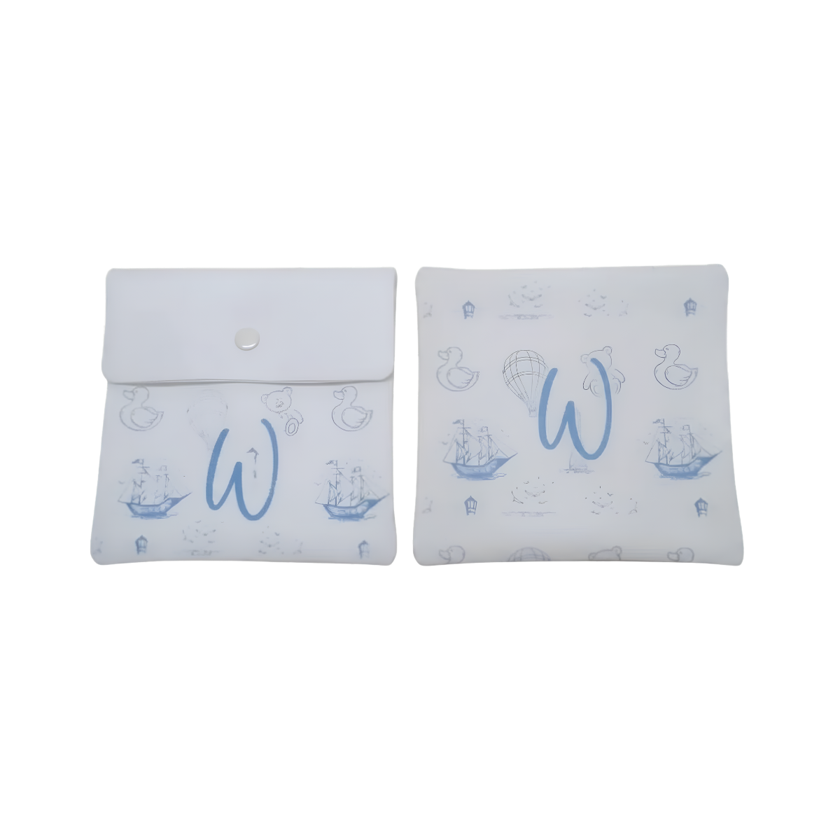 Personalized white baby gift pouches and decorative pillows featuring a light blue monogram “W” and delicate nautical-themed illustrations.