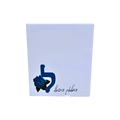 Personalized white gift box featuring a blue Hebrew letter, blue floral embellishment, and handwritten Hebrew text.