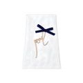 White personalized gift pouch with a navy blue ribbon, gold script monogram, and decorative hanging cord.