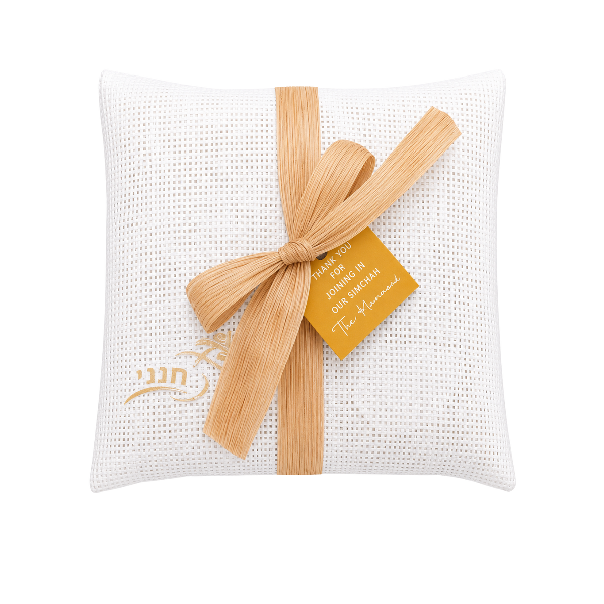 White textured fabric pouch decorated with a beige ribbon tied in a large bow, a small tan tag with gold lettering, and subtle gold details near the bottom.
