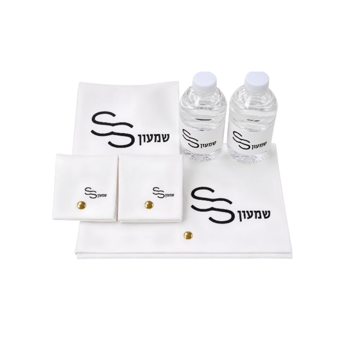 White personalized fabric gift set with black lettering, two small water bottles, folded pouches, and matching accessories arranged together.