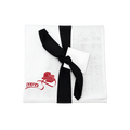 White textured fabric gift pouch wrapped with a black ribbon and bow, featuring a small white tag and red embroidered Hebrew lettering.