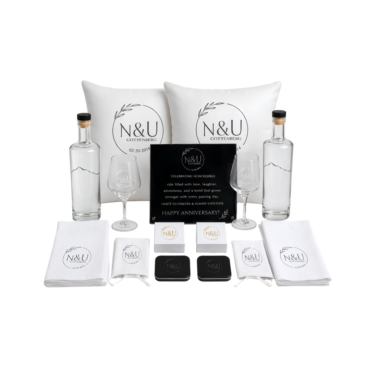 White and black gift set featuring personalized pouches, small gift bags, labeled boxes, and decorative packaging arranged together.