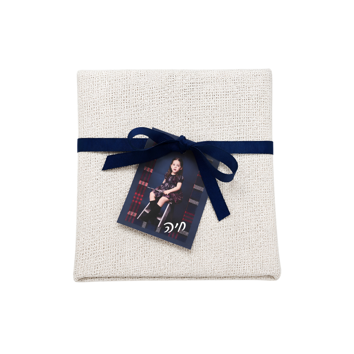 Personalized white linen gift pouch with a navy blue ribbon, featuring a decorative photo tag attached to the front.