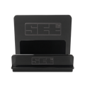 Black rectangular electronic device with a matching black case, featuring a subtle geometric logo and control buttons on the front.
