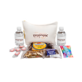 Personalized gift basket featuring a white decorative pillow, two matching bottles, assorted snacks, and packaged treats with Hebrew text and colorful labels.