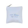 White decorative throw pillow featuring a short personalized message in blue Hebrew and English script.